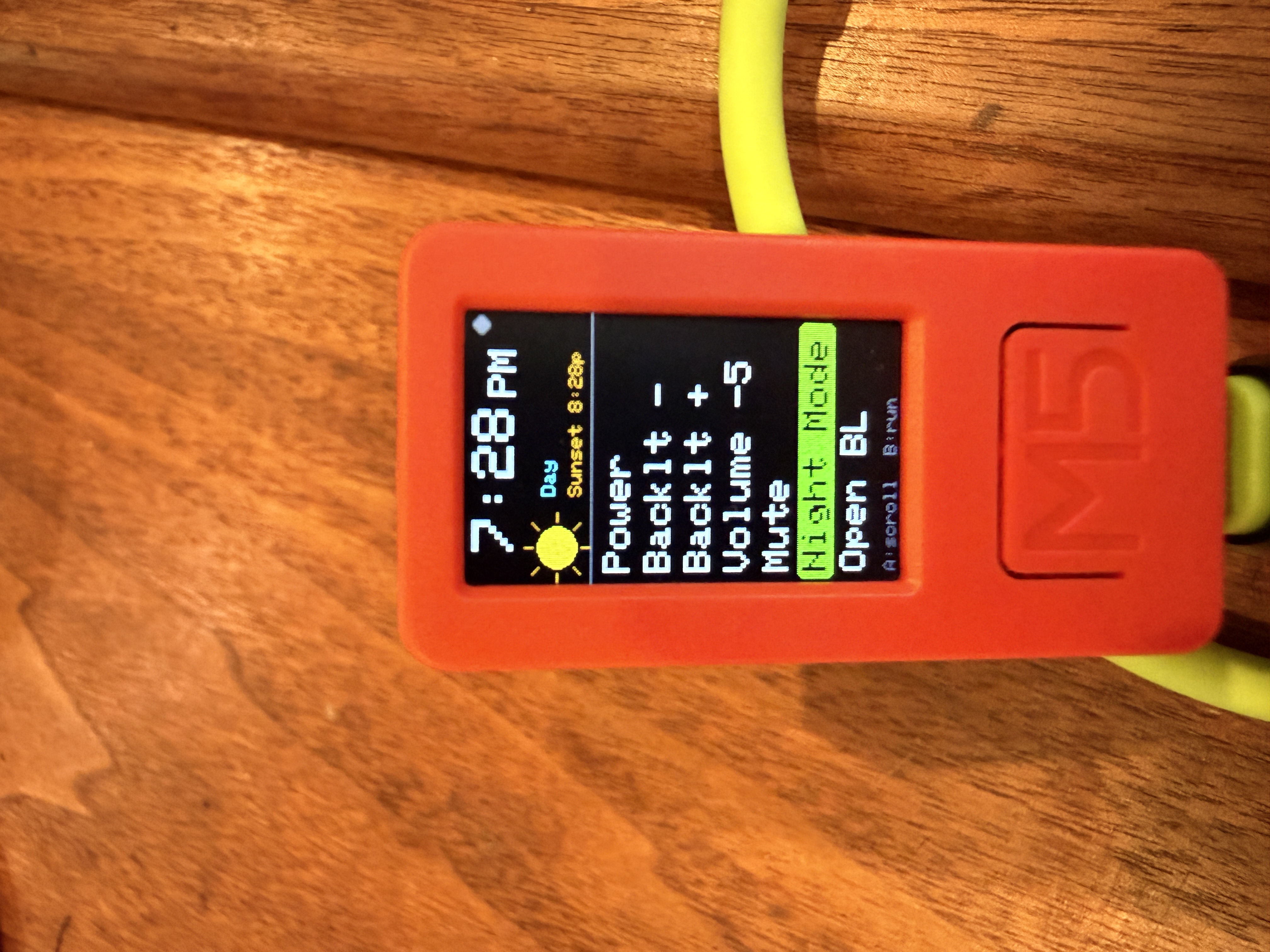 The device screen: 12-hour clock, sunset time, day-phase icon, and the macro list